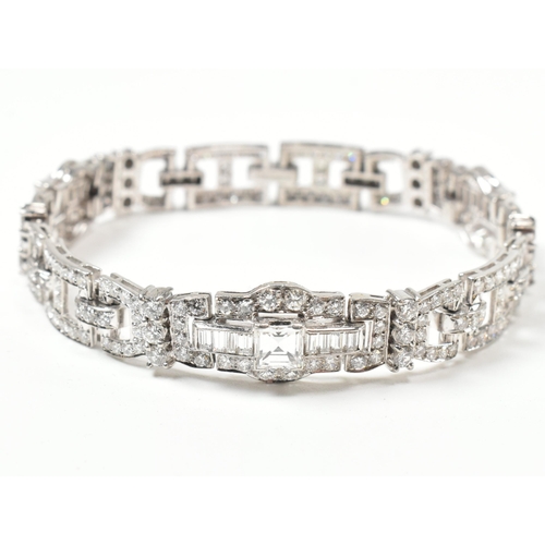 9 - An Art Deco platinum and diamond bracelet. The bracelet having geometric diamond set links to clip c... 