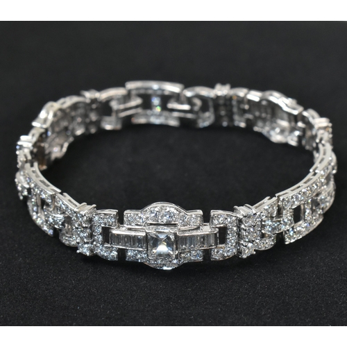 9 - An Art Deco platinum and diamond bracelet. The bracelet having geometric diamond set links to clip c... 