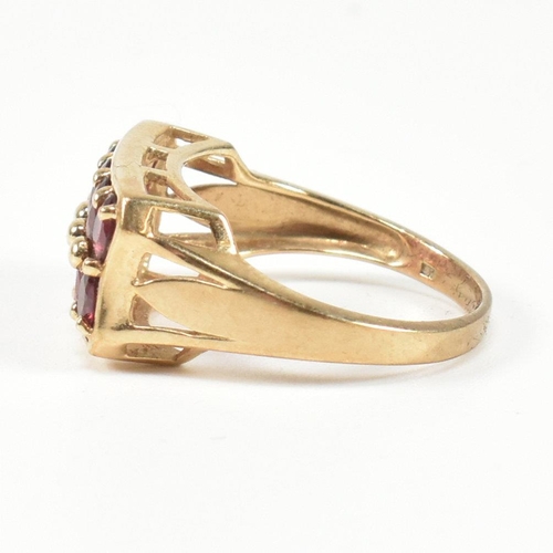 90 - A hallmarked 9ct gold and garnet ring. The ring set with two rows of five oval cut garnets in a rect... 