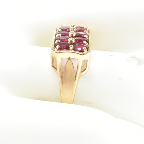 90 - A hallmarked 9ct gold and garnet ring. The ring set with two rows of five oval cut garnets in a rect... 