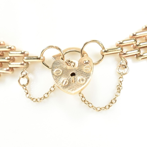 92 - A hallmarked 9ct gold gate link bracelet with heart padlock clasp. The 9ct gold gate link having a h... 