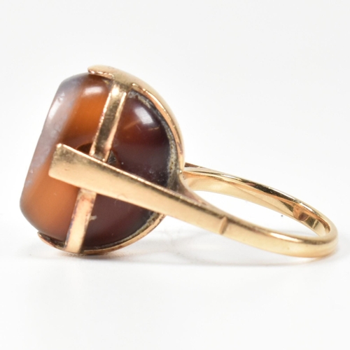 94 - A 14ct gold and carved agate intaglio seal ring. The ring having a carved intaglio bead mounted on i... 