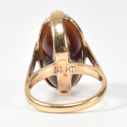 94 - A 14ct gold and carved agate intaglio seal ring. The ring having a carved intaglio bead mounted on i... 