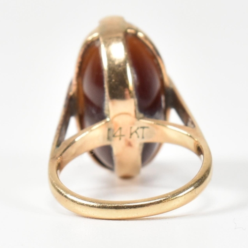 94 - A 14ct gold and carved agate intaglio seal ring. The ring having a carved intaglio bead mounted on i... 