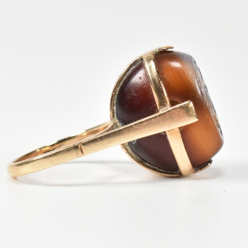 94 - A 14ct gold and carved agate intaglio seal ring. The ring having a carved intaglio bead mounted on i... 