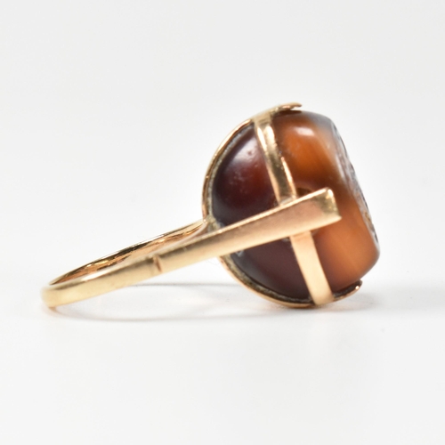 94 - A 14ct gold and carved agate intaglio seal ring. The ring having a carved intaglio bead mounted on i... 