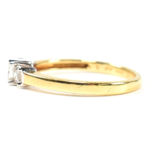 97 - A hallmarked 18ct gold and diamond three stone ring. The ring set with three princess cut diamonds t... 