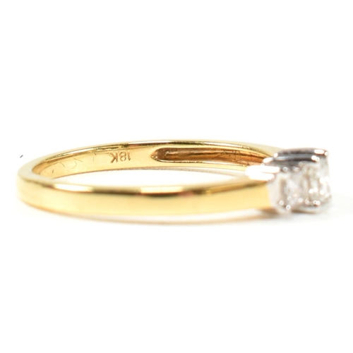 97 - A hallmarked 18ct gold and diamond three stone ring. The ring set with three princess cut diamonds t... 