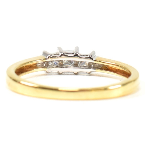 97 - A hallmarked 18ct gold and diamond three stone ring. The ring set with three princess cut diamonds t... 