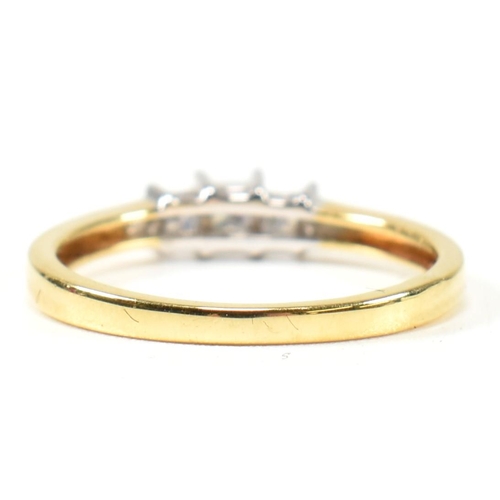 97 - A hallmarked 18ct gold and diamond three stone ring. The ring set with three princess cut diamonds t... 