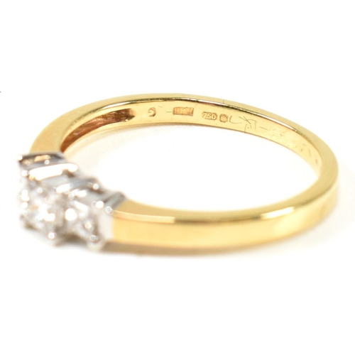 97 - A hallmarked 18ct gold and diamond three stone ring. The ring set with three princess cut diamonds t... 