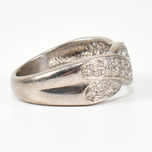 98 - A hallmarked 18ct white gold and diamond twist ring. The ring having a two strand twist design, set ... 