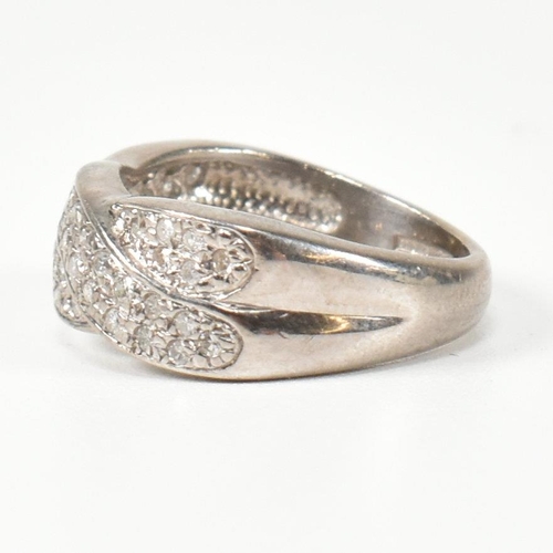 98 - A hallmarked 18ct white gold and diamond twist ring. The ring having a two strand twist design, set ... 