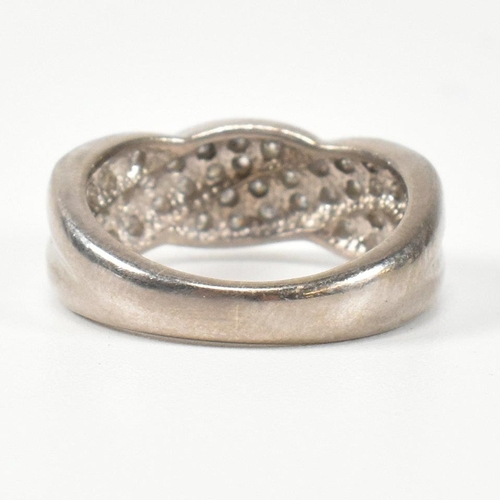 98 - A hallmarked 18ct white gold and diamond twist ring. The ring having a two strand twist design, set ... 