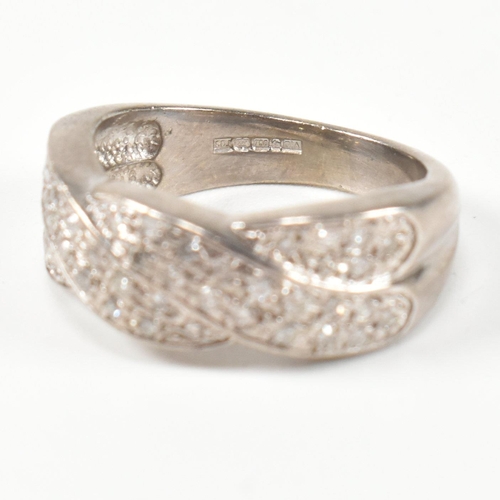 98 - A hallmarked 18ct white gold and diamond twist ring. The ring having a two strand twist design, set ... 