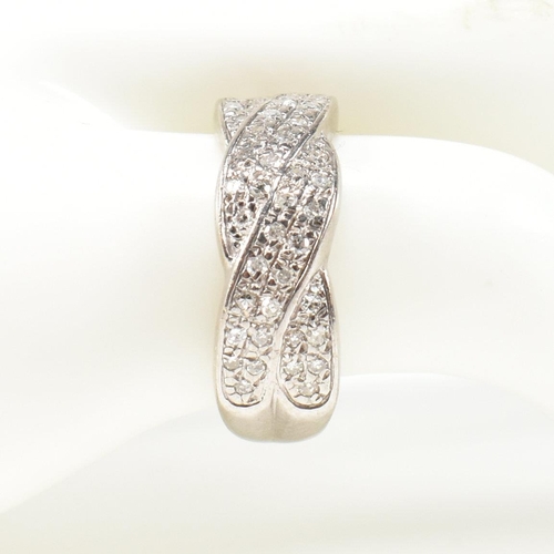 98 - A hallmarked 18ct white gold and diamond twist ring. The ring having a two strand twist design, set ... 