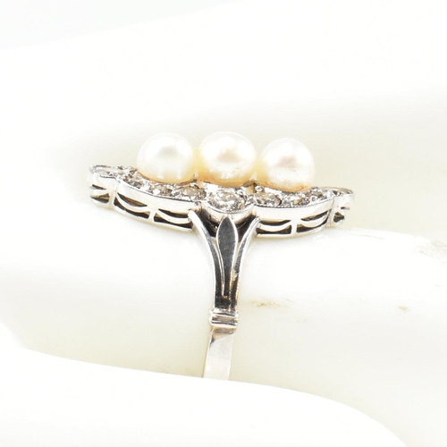 205 - A pearl and diamond marquise ring. The ring set with a line of pearls, framed by round brilliant cut... 