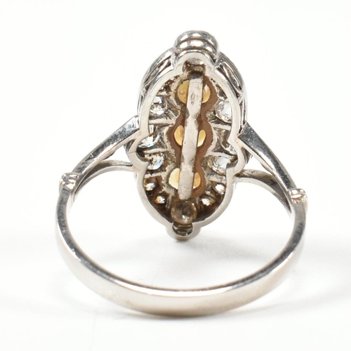 205 - A pearl and diamond marquise ring. The ring set with a line of pearls, framed by round brilliant cut... 