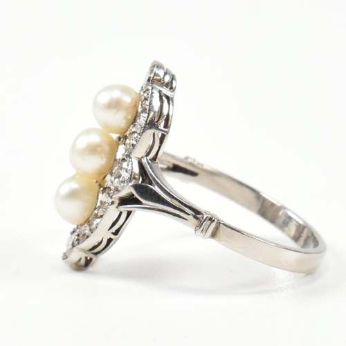 205 - A pearl and diamond marquise ring. The ring set with a line of pearls, framed by round brilliant cut... 