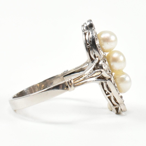 205 - A pearl and diamond marquise ring. The ring set with a line of pearls, framed by round brilliant cut... 