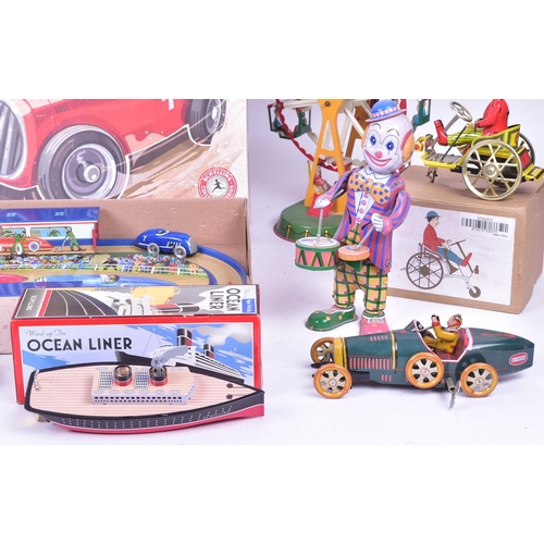 114 - Tinplate Toys - a collection of assorted tinplate clockwork mechanical toys to include a boxed Schyl... 