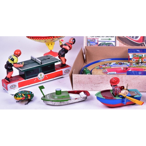 114 - Tinplate Toys - a collection of assorted tinplate clockwork mechanical toys to include a boxed Schyl... 