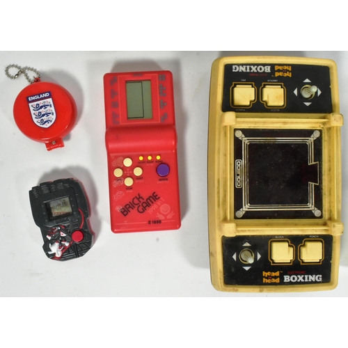 471 - Retro Gaming - a collection of vintage tabletop and hand held video game consoles to include; boxed ... 