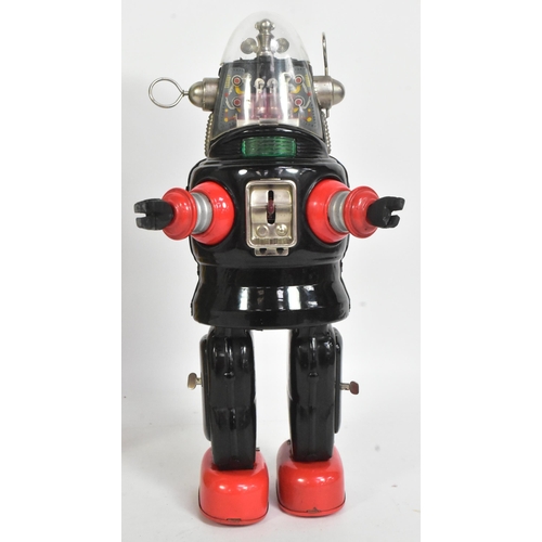 500 - A vintage Japanese tinplate battery operated mechanized Robby The Robot. Black and red with rubber h... 