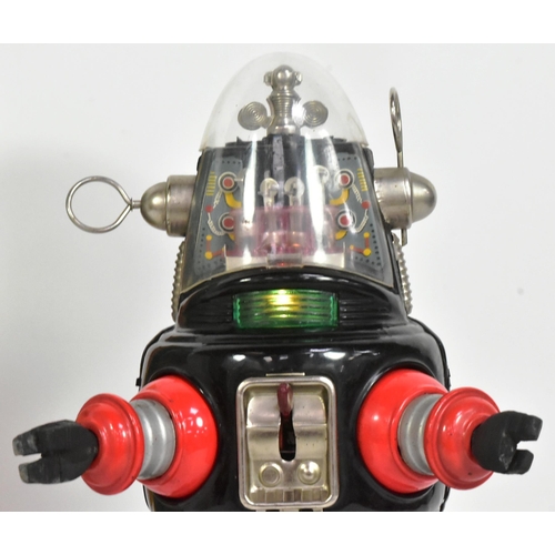 500 - A vintage Japanese tinplate battery operated mechanized Robby The Robot. Black and red with rubber h... 