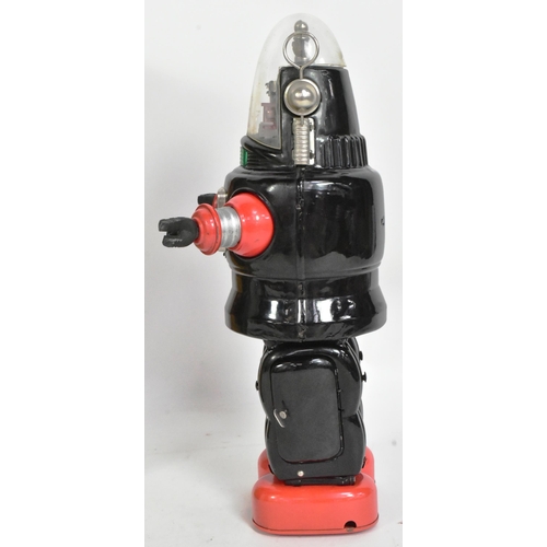 500 - A vintage Japanese tinplate battery operated mechanized Robby The Robot. Black and red with rubber h... 