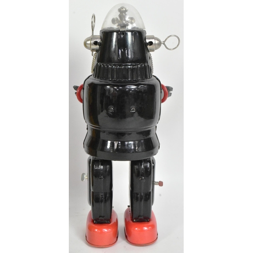 500 - A vintage Japanese tinplate battery operated mechanized Robby The Robot. Black and red with rubber h... 