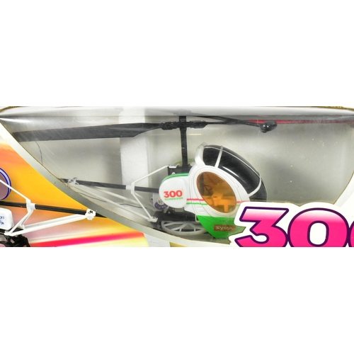 519 - Radio Control - x2 boxed RC Radio Control model helicopters comprising a Syma made 300 Schweizer and... 