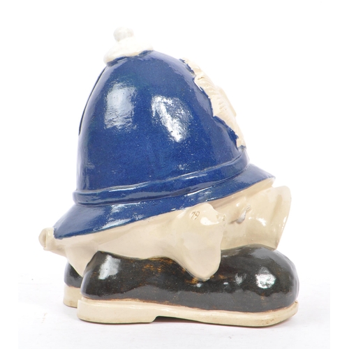 107 - A 20th Century vintage ceramic money box figure in the form of a pig's head sat upon large boots, we... 