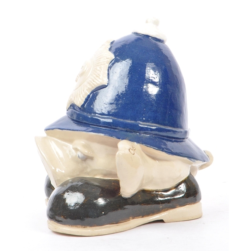 107 - A 20th Century vintage ceramic money box figure in the form of a pig's head sat upon large boots, we... 