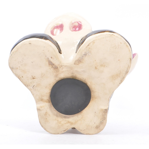 107 - A 20th Century vintage ceramic money box figure in the form of a pig's head sat upon large boots, we... 