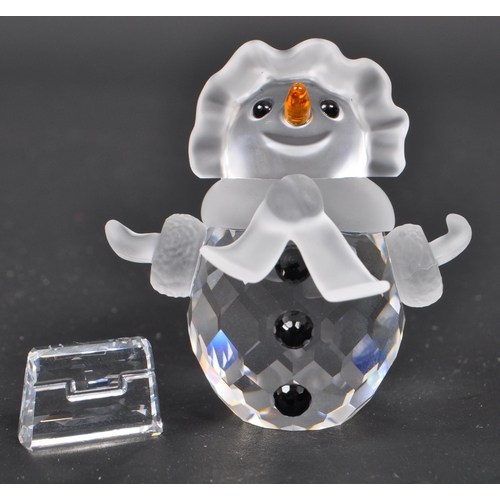 109 - Swarovski - A collection of boxed Swarovski crystal Christmas ornaments and figures. The collection ... 