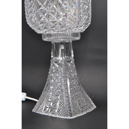 114 - A 20th Century cut glass electric crystal table lamp light comprising of base and shade, the base of... 