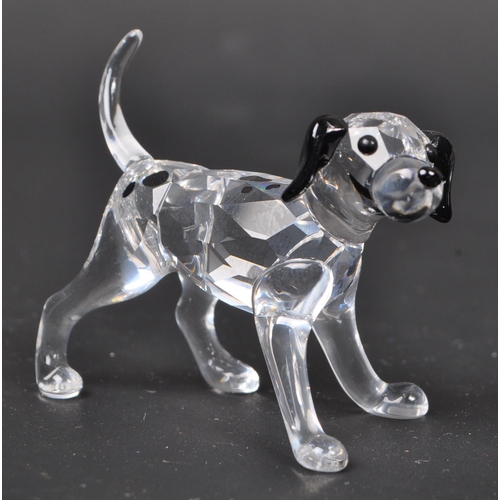 116 - Swarovski - A collection of boxed Swarovski crystal dog figure ornaments. The collection to include ... 