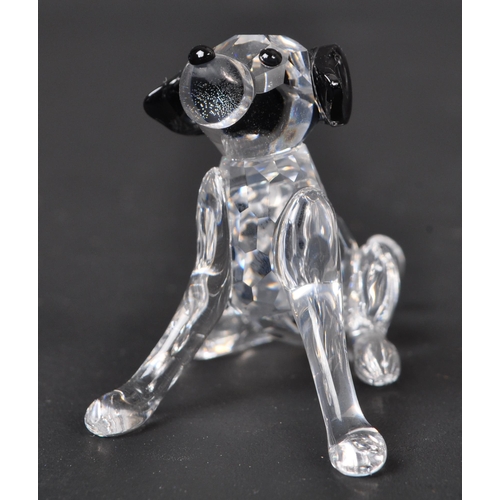 116 - Swarovski - A collection of boxed Swarovski crystal dog figure ornaments. The collection to include ... 