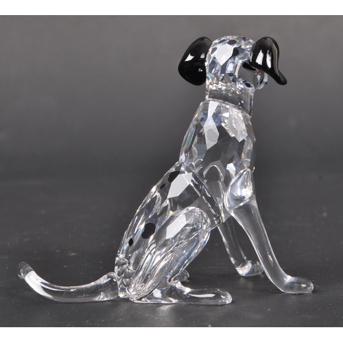 116 - Swarovski - A collection of boxed Swarovski crystal dog figure ornaments. The collection to include ... 