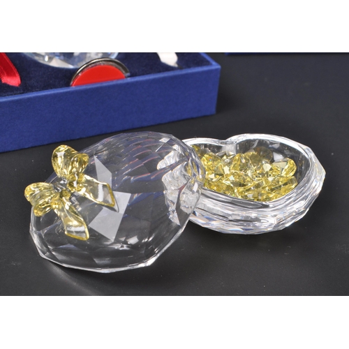 124 - Swarovski - A collection of boxed Swarovski crystal decorative heart ornaments. The collection to in... 