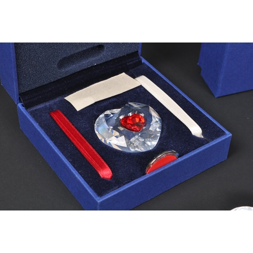 124 - Swarovski - A collection of boxed Swarovski crystal decorative heart ornaments. The collection to in... 