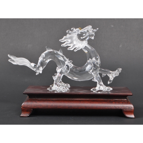 128 - Swarovski - A boxed Swarovski 'Fables and Tales' collection Crystal Zodiacs decorative dragon figure... 