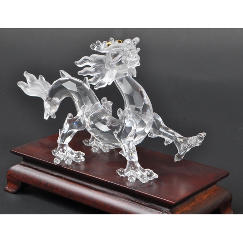 128 - Swarovski - A boxed Swarovski 'Fables and Tales' collection Crystal Zodiacs decorative dragon figure... 