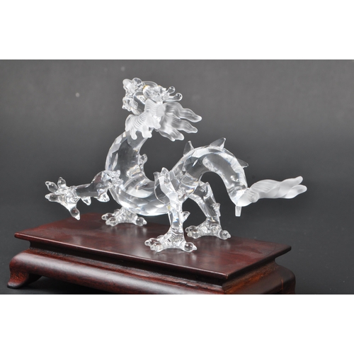 128 - Swarovski - A boxed Swarovski 'Fables and Tales' collection Crystal Zodiacs decorative dragon figure... 