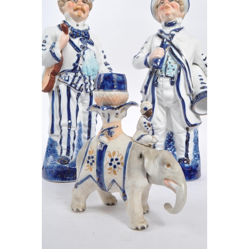 140 - Two vintage Staffordshire ceramic figures in the form of Victorian dressed men carrying instruments ... 