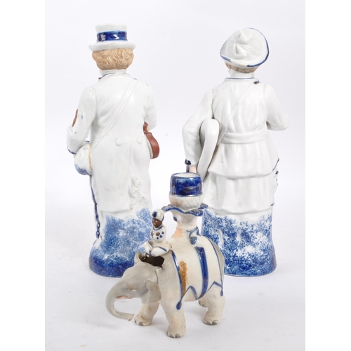 140 - Two vintage Staffordshire ceramic figures in the form of Victorian dressed men carrying instruments ... 