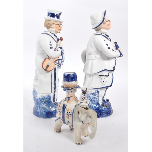 140 - Two vintage Staffordshire ceramic figures in the form of Victorian dressed men carrying instruments ... 