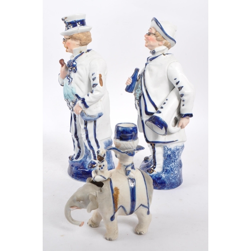 140 - Two vintage Staffordshire ceramic figures in the form of Victorian dressed men carrying instruments ... 