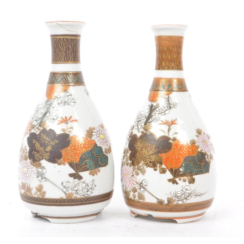 145 - A collection of five Japanese porcelain vase to include a pair of satsuma pottery vases having white... 